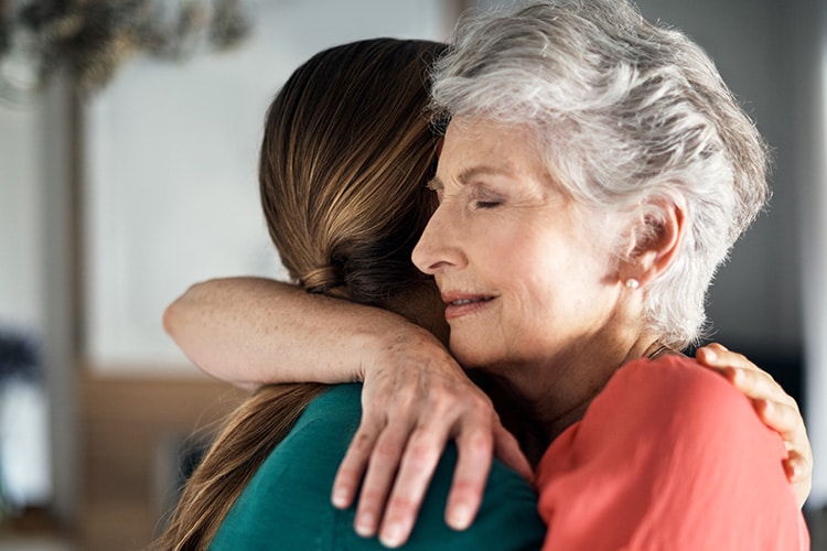 Mother and daughter hugging